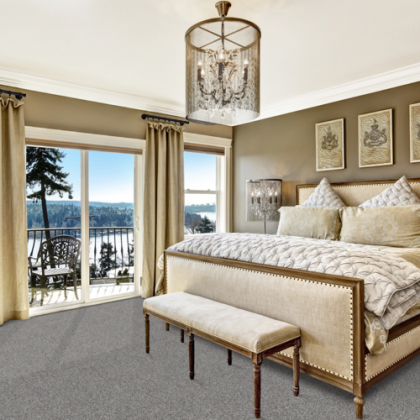 A bedroom with a large bed and a bench