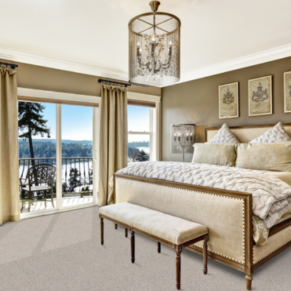 A bedroom with a large bed and a bench