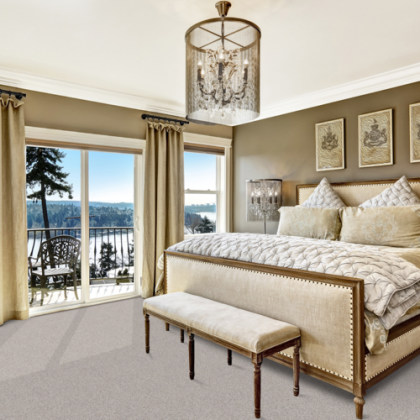 A bedroom with a large bed and a bench