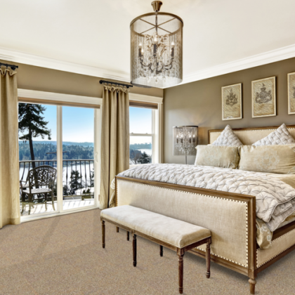 A bedroom with a large bed and a bench