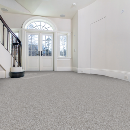 An empty room with a staircase and a door