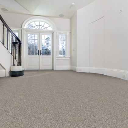 An empty room with a staircase and a door