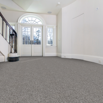 An empty room with a staircase and a door