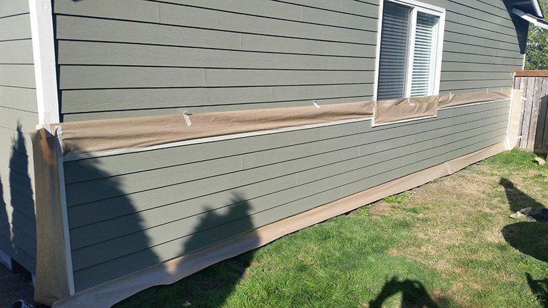 Ongoing painting of the side of a house