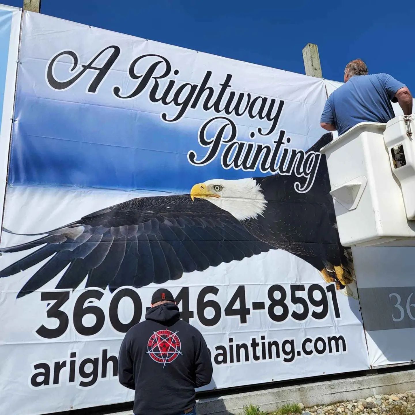 Installing A Rightway Painting LLC's tarp sign