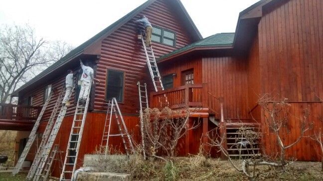 3 painters working on a house