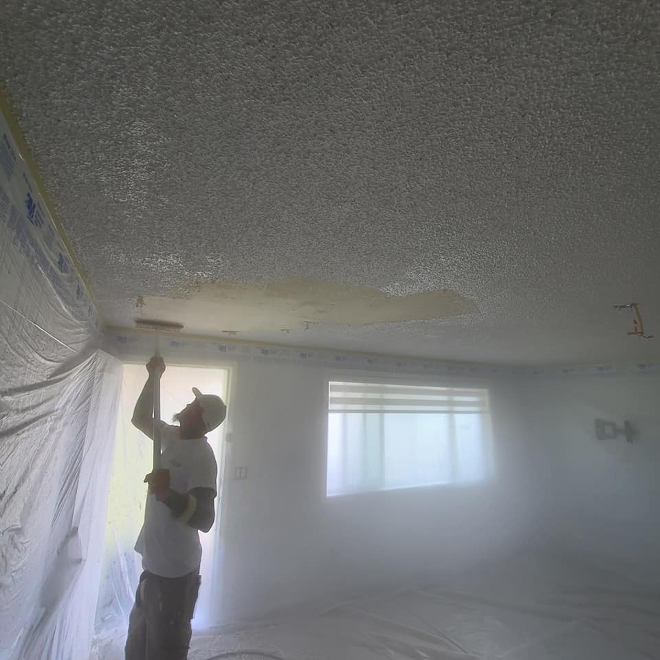 Painter applying textured ceiling