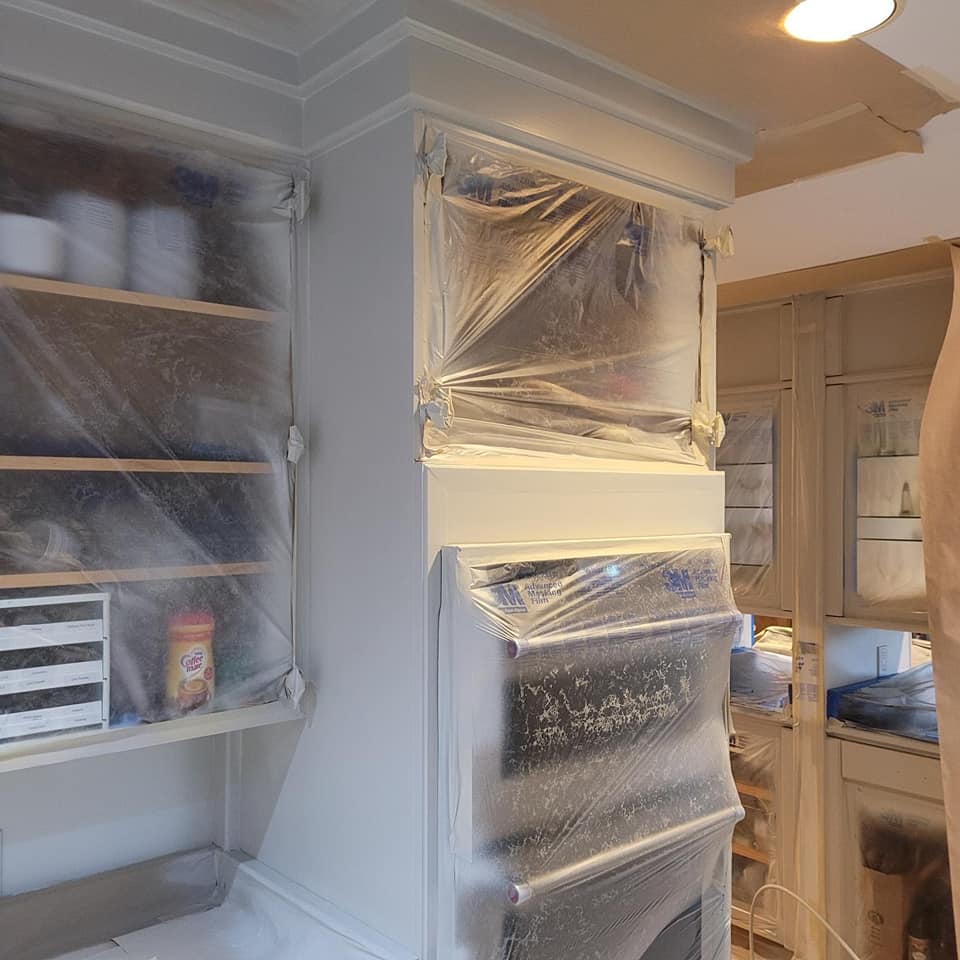 Kitchen appliances covered with plastic to protect from paint
