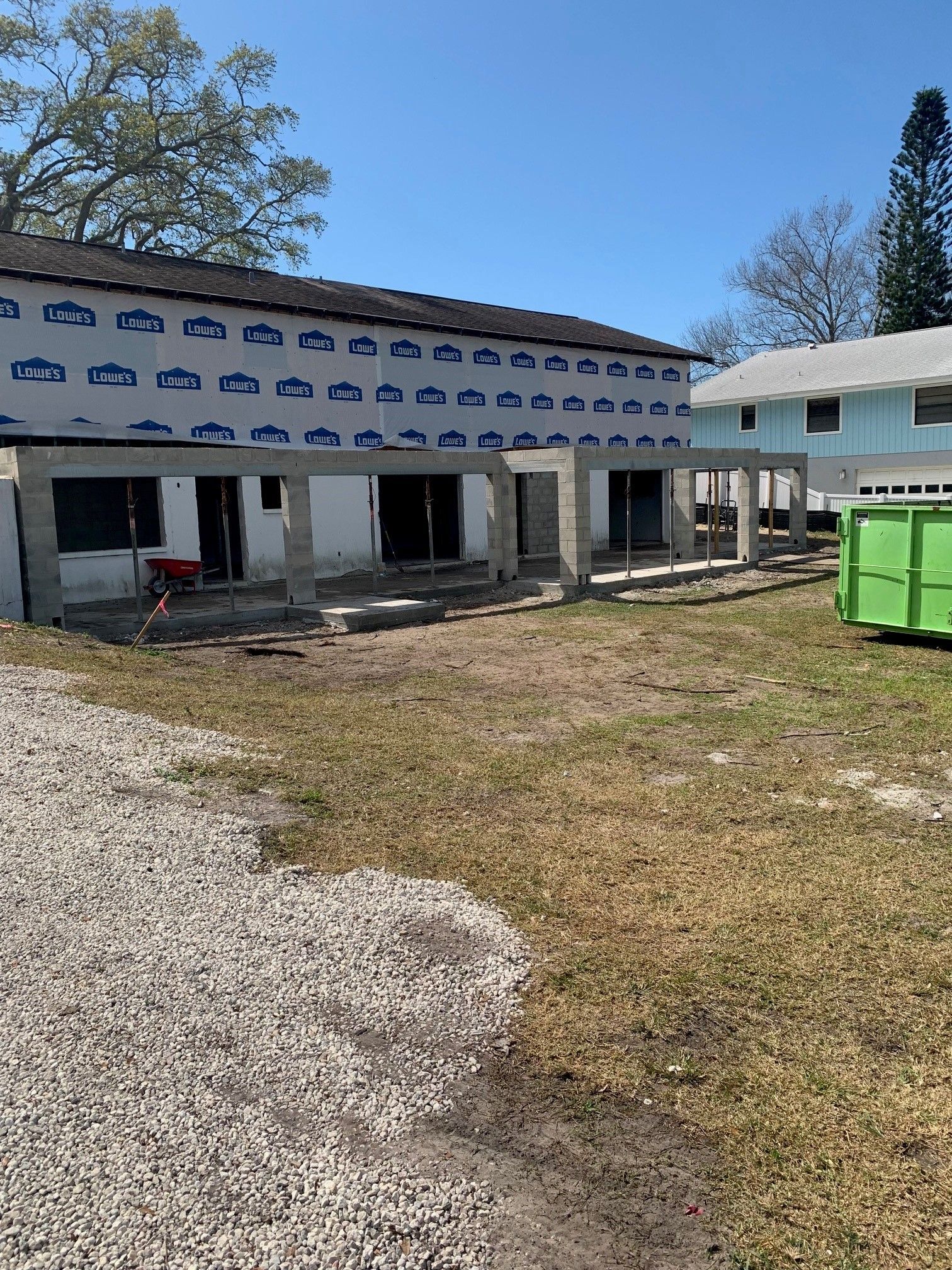 A truck is parked in front of a brick building next to a concrete area.