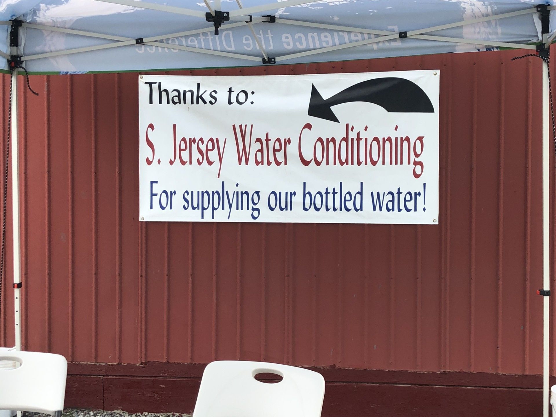 Banner thanking S. Jersey Water Conditioning for supplying bottled water on a red building