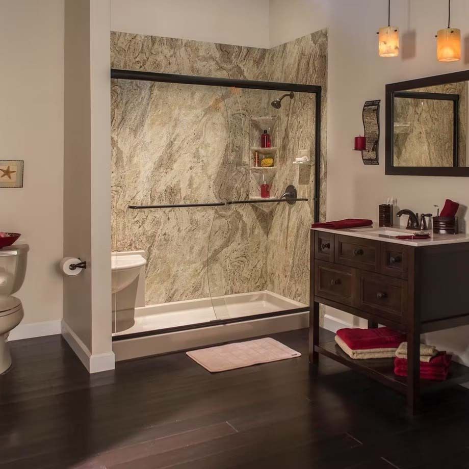 Modern bathroom with marble shower, dark vanity, mirror, and dark wood floor