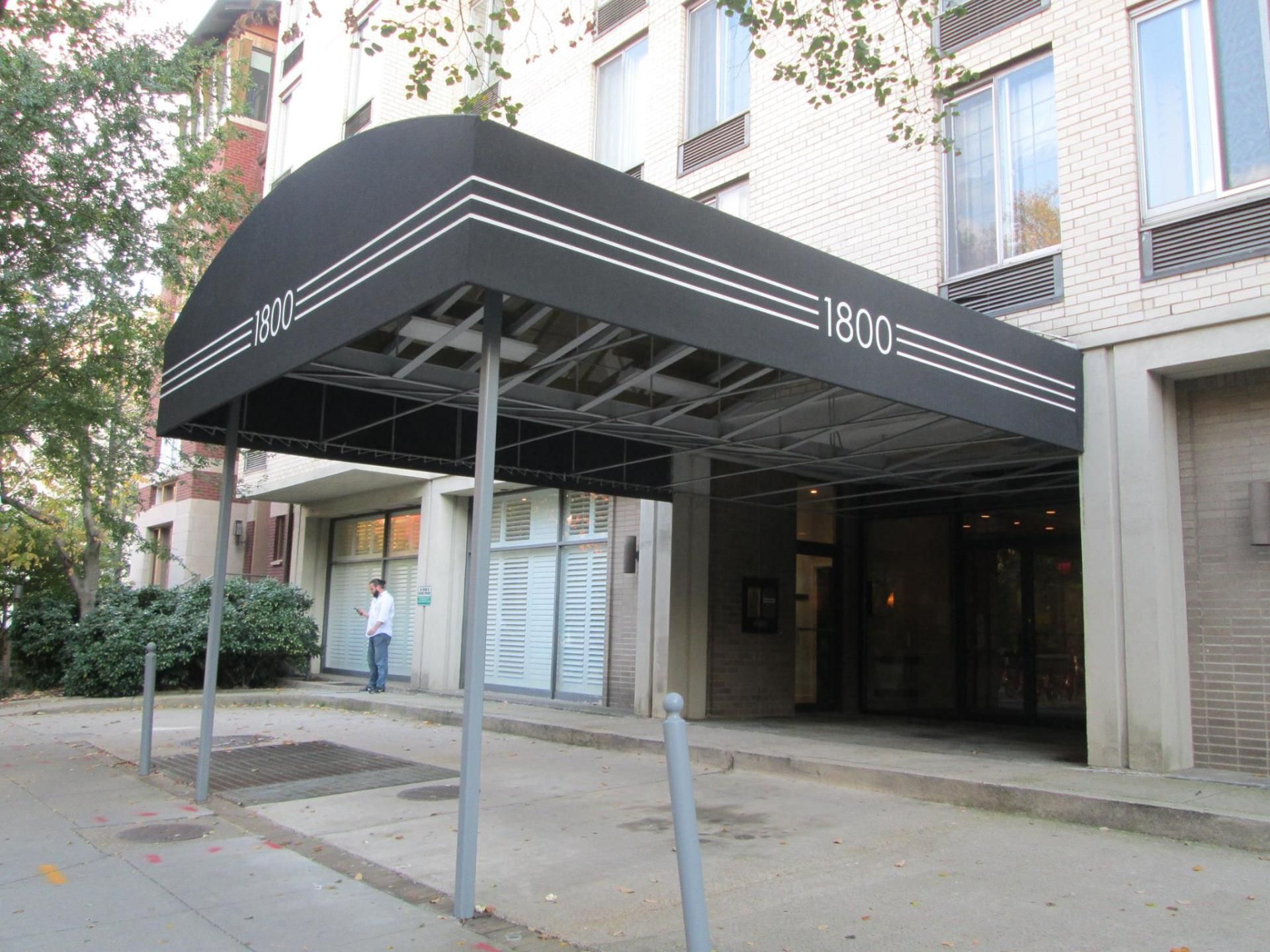 A building with a canopy over the entrance that says 1800.