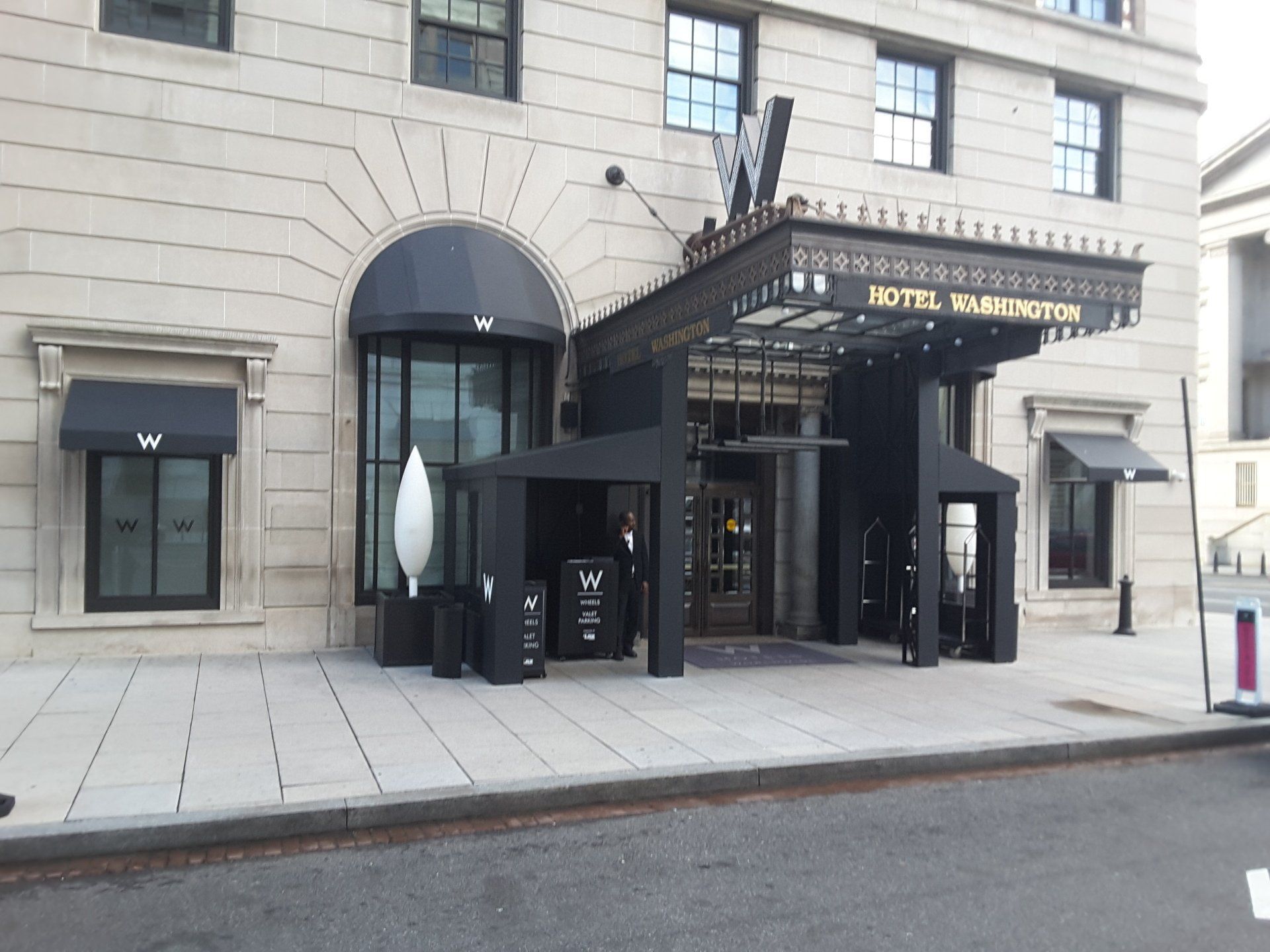 A large building with a black awning over the entrance.