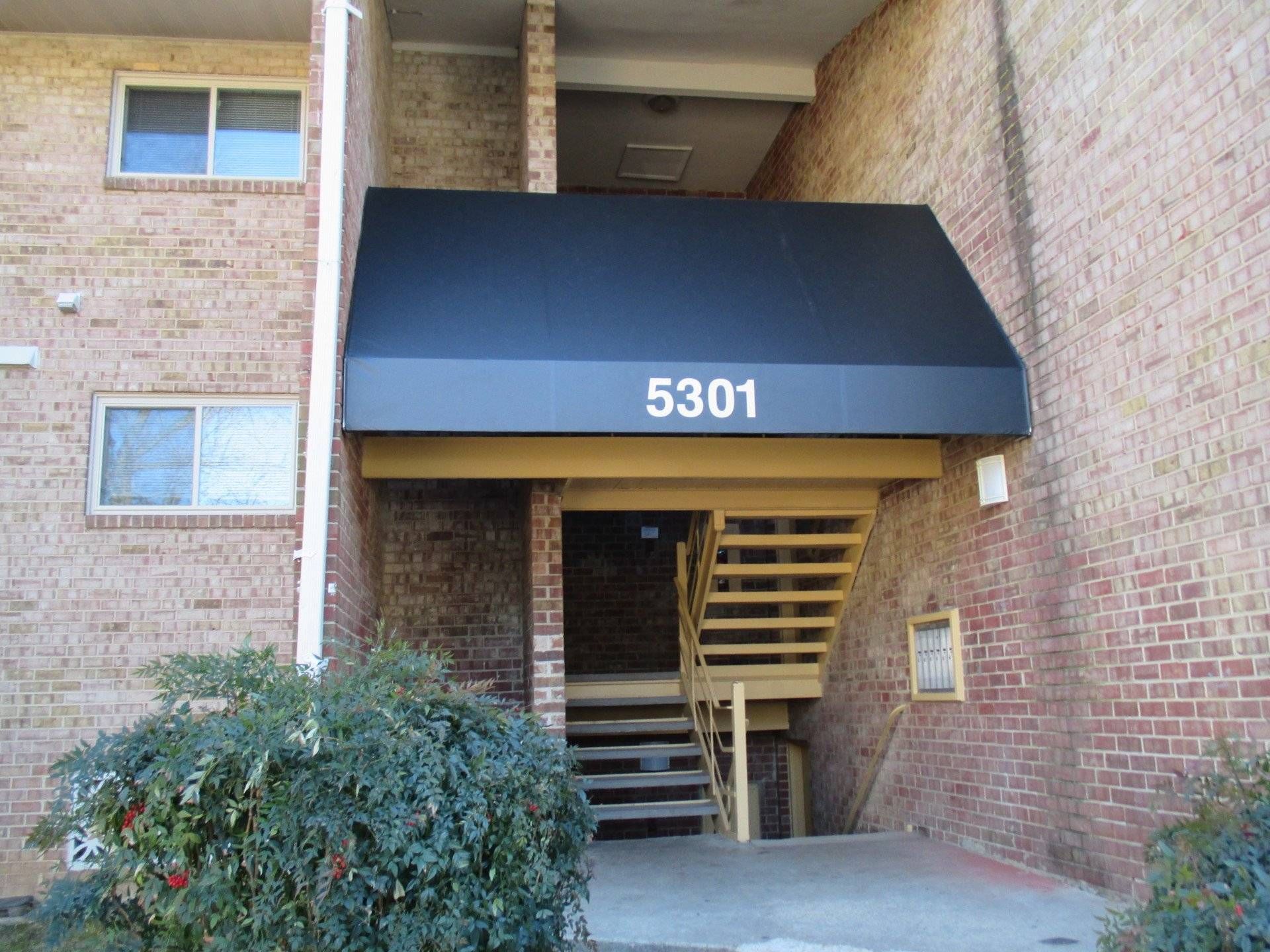 A black awning with the number 5301 on it.