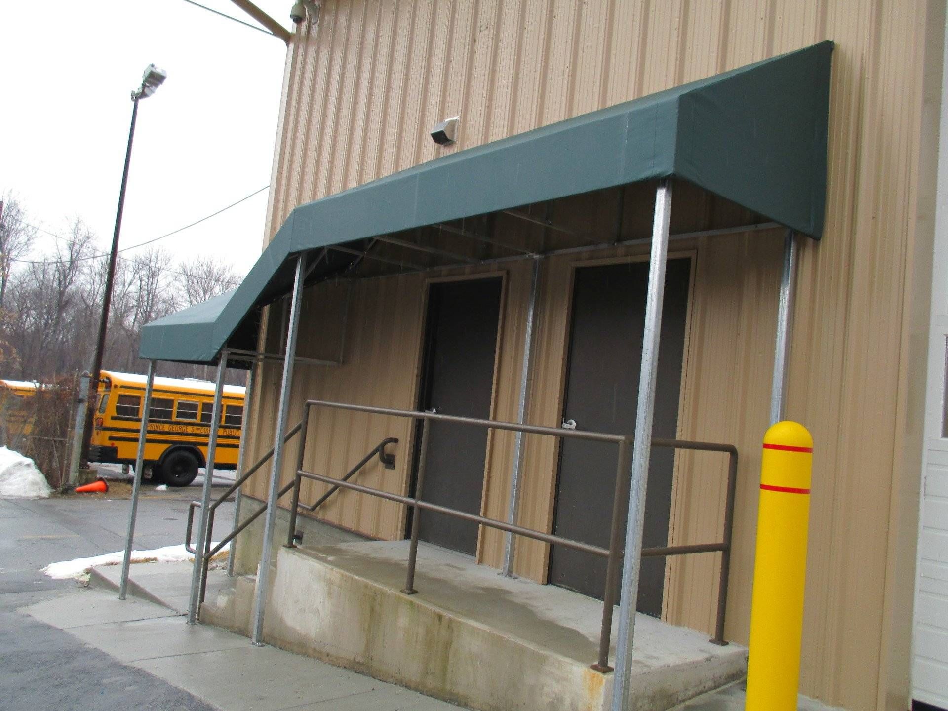 A yellow school bus is parked in front of a building.
