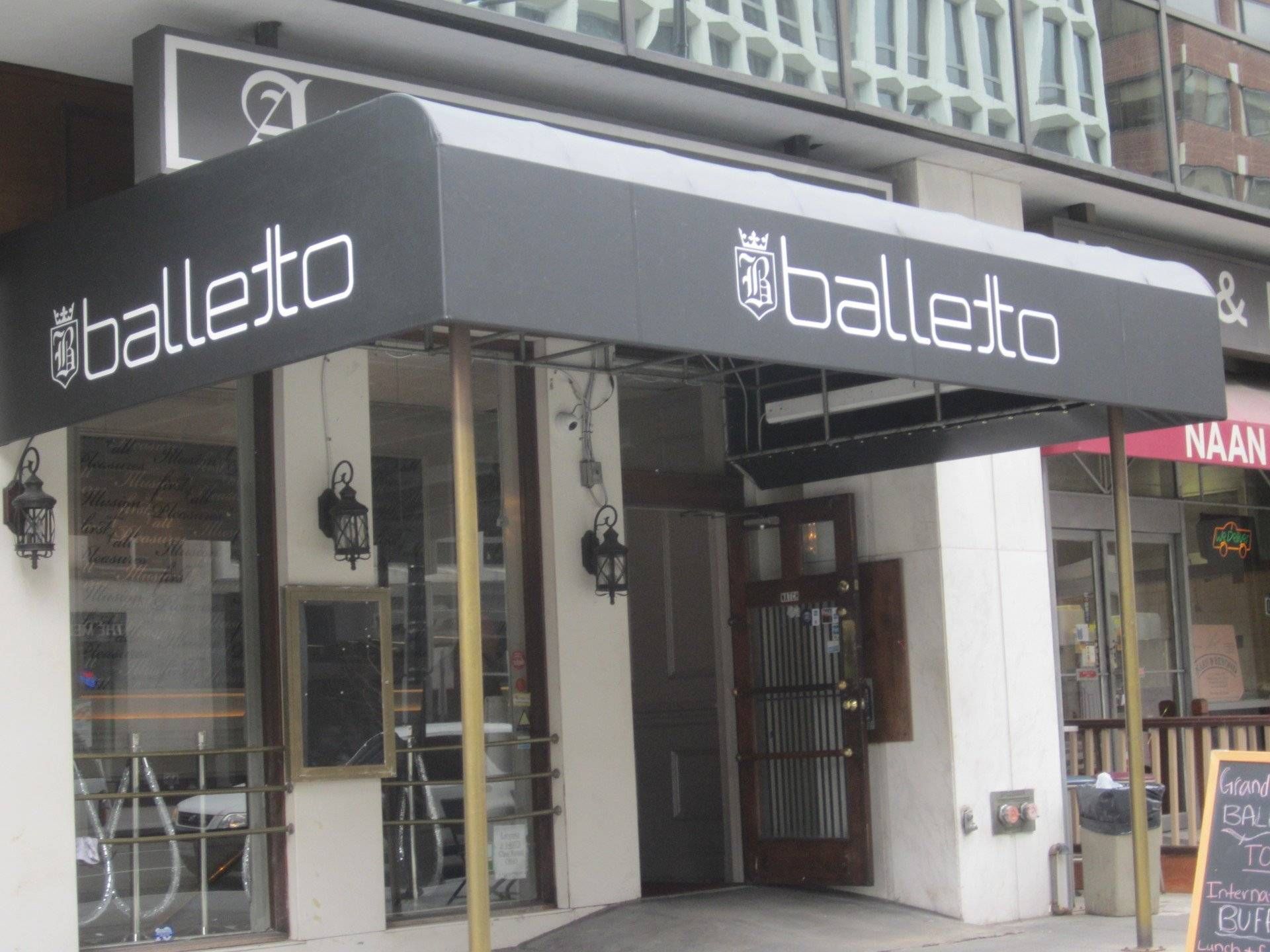 A white building with a black awning that says Balleto.