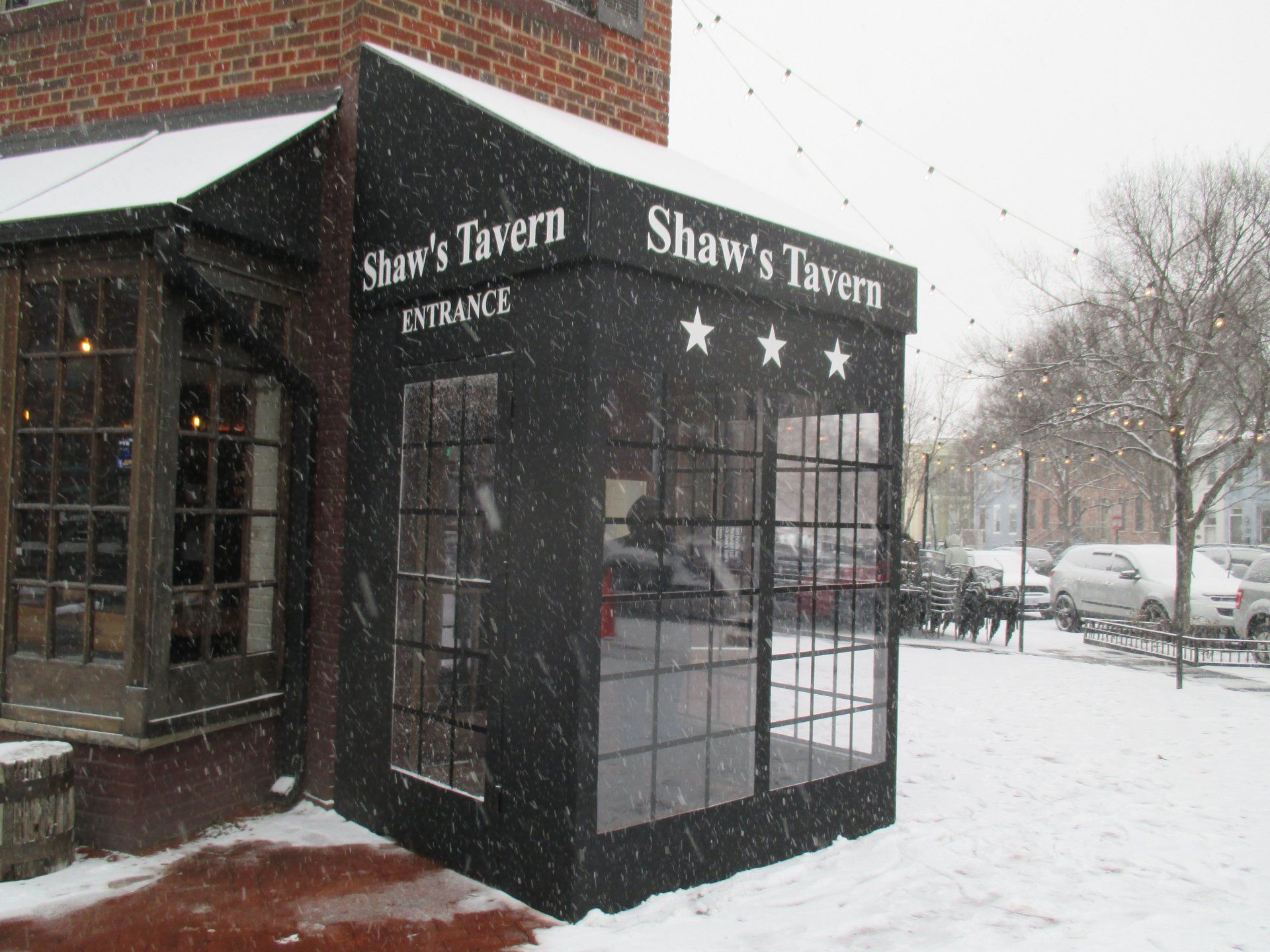 The entrance to Shaw 's Tavern is covered in snow.