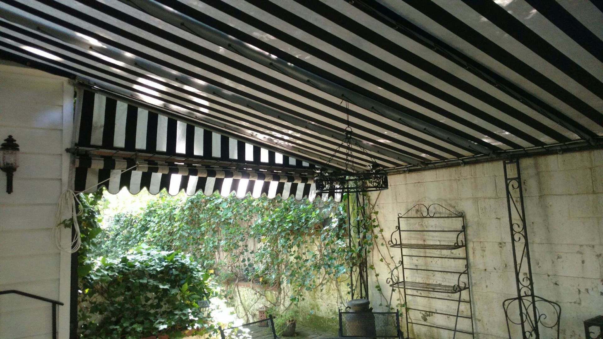 A black and white awning is hanging from the ceiling of a building.