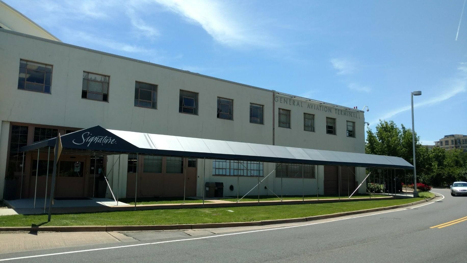 A large building with a canopy on the side of it.