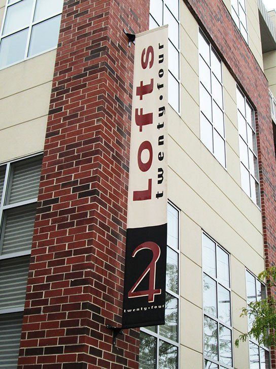 A brick building with a banner that says Lofts on it.