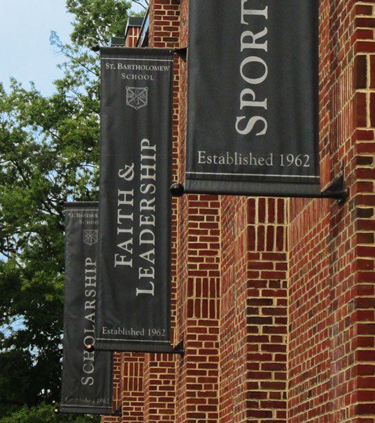 A brick building with a banner that says Faith and Leadership.
