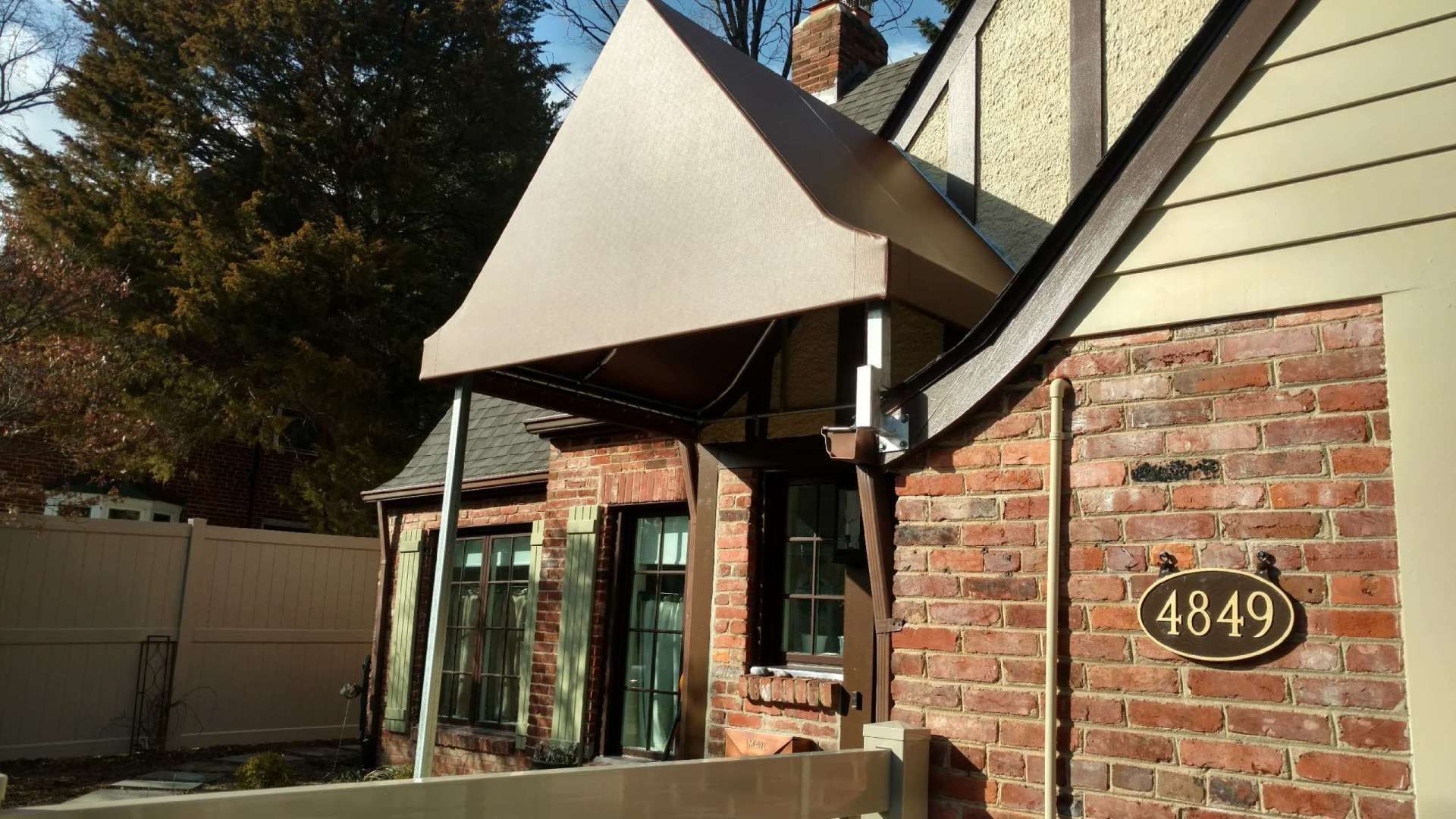 A brick house with a sign that says 1849 on it.