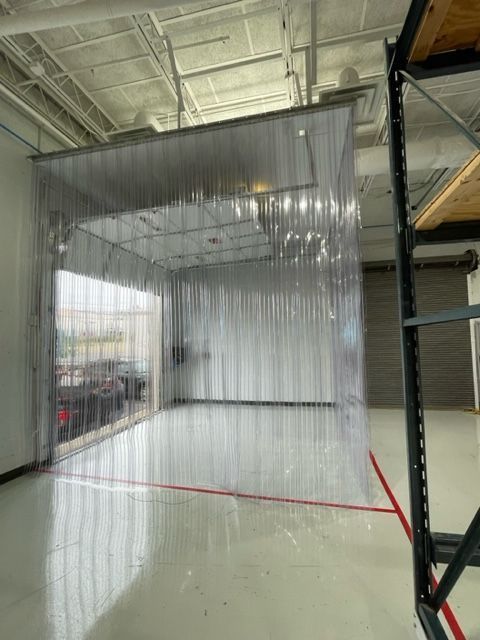 A large room with a clear curtain hanging from the ceiling.