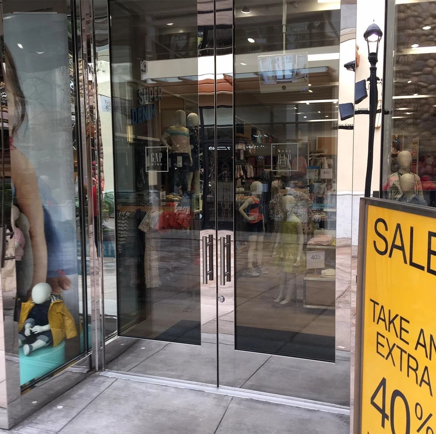 Storefront with glass doors, mannequins, and a 