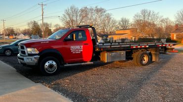 McCool Semi Repair & Roadside Services' red towing truck