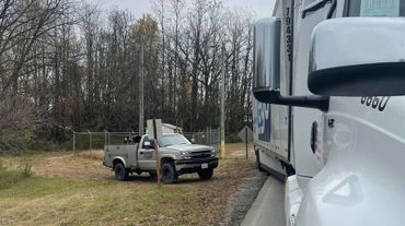 McCool Semi Repair & Roadside Services' white service gray pickup and a huge white truck