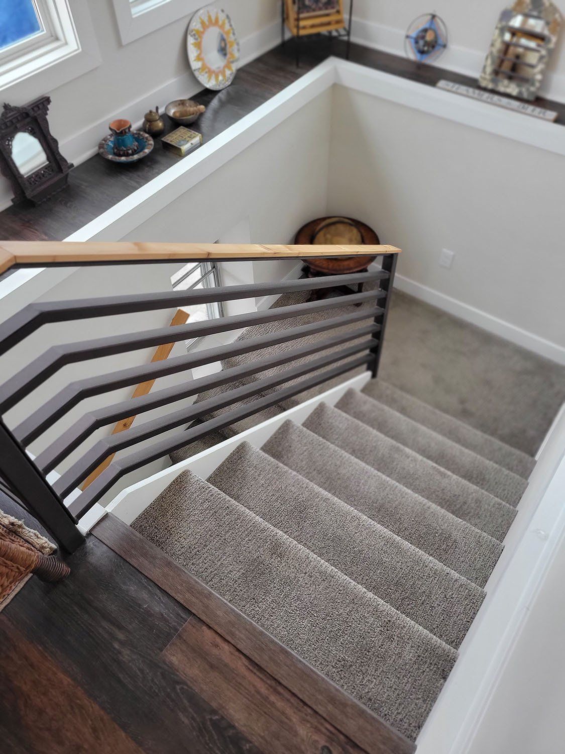 Stairs with a beautiful beige and black railing
