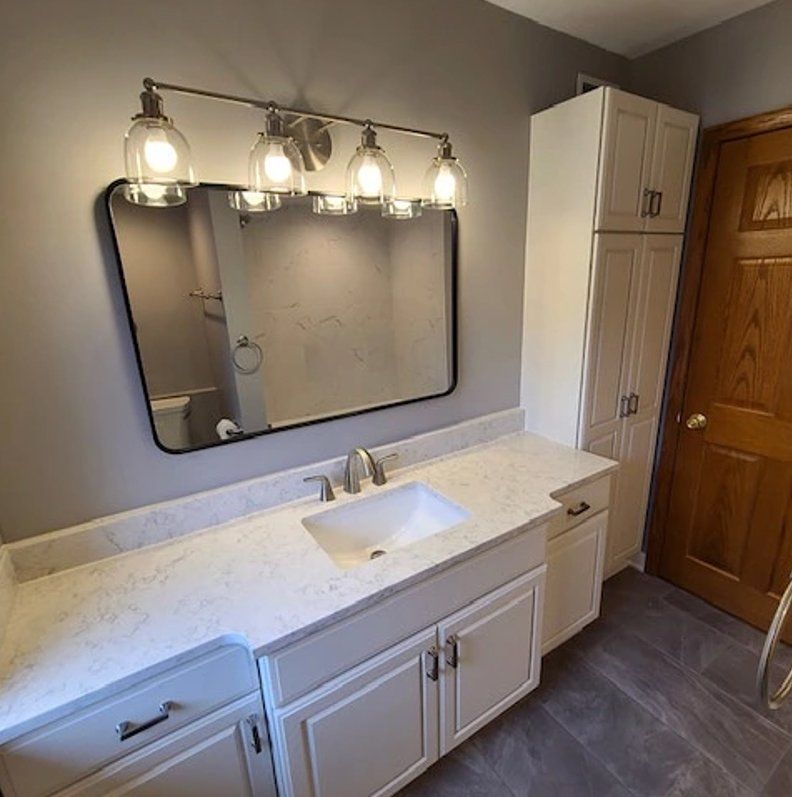 Bathroom sink with an elegant lighting fixture