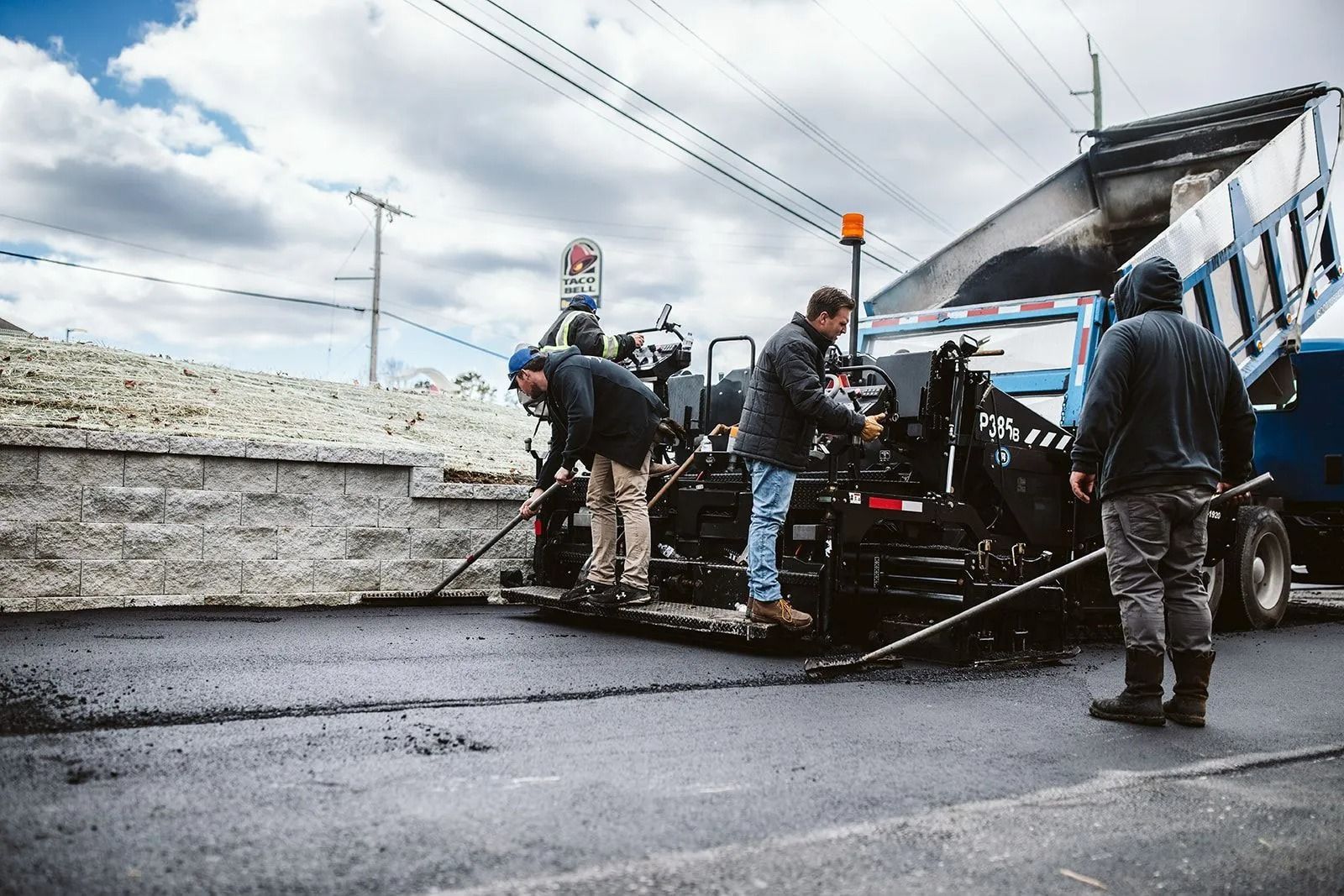 Road workers paving a street with asphalt.