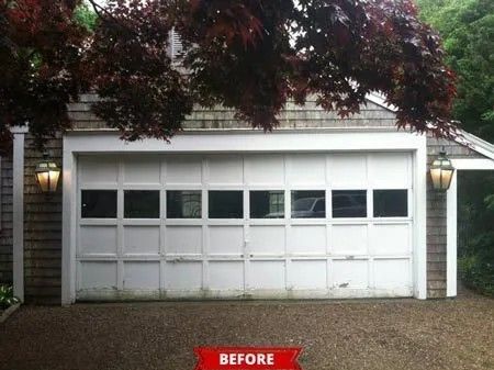 White garage with small windows under leafy trees, labeled 