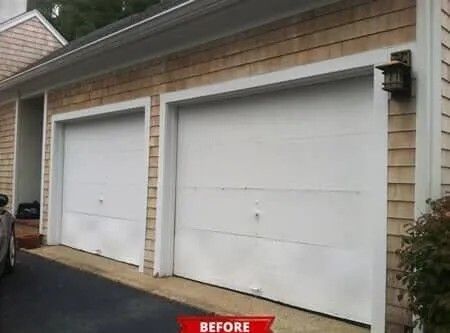 Two white garage doors on a tan-sided house, with a red “BEFORE” label at the bottom.