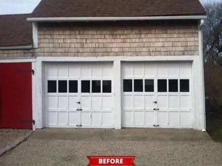 Before view of a white double garage door with small windows and a red side door.