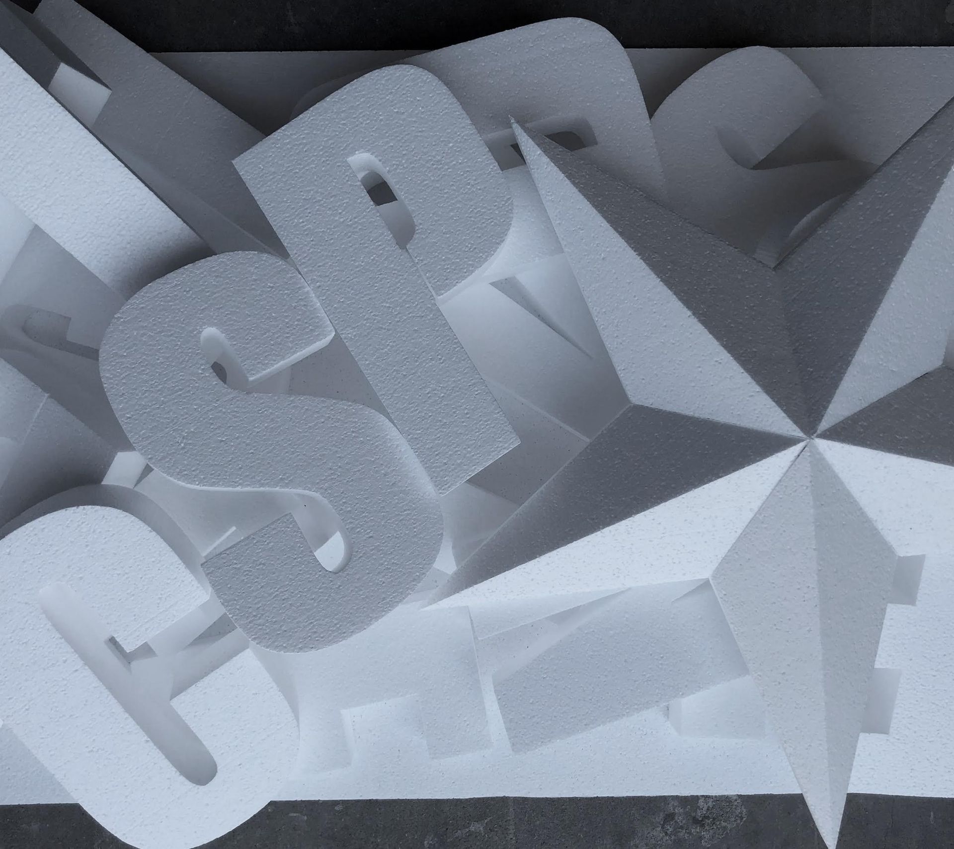 A stack of styrofoam letters including the letter s
