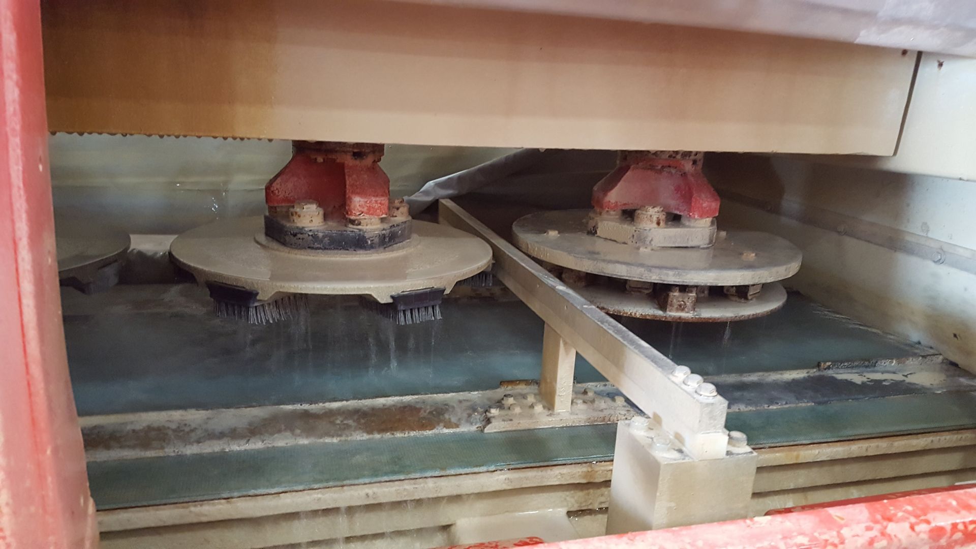 A machine is sitting on top of a conveyor belt in a room.