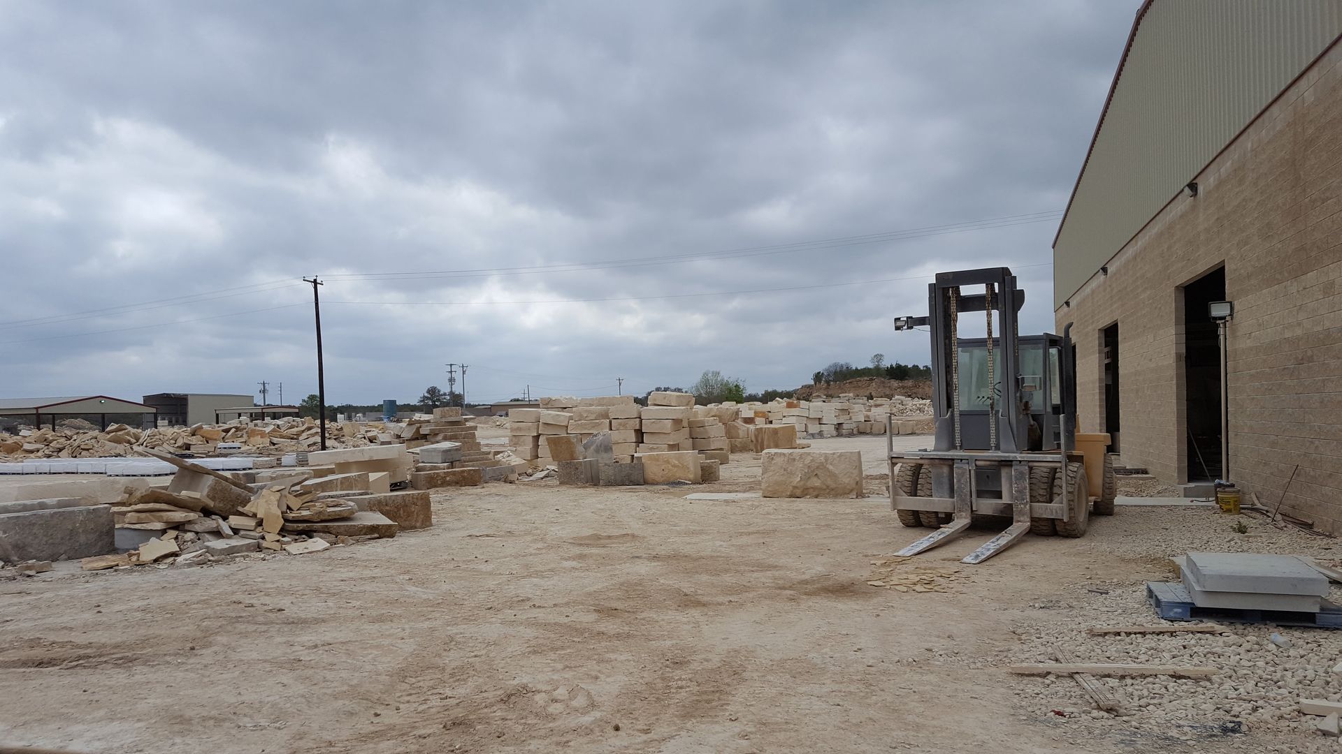 A forklift is parked in front of a large building