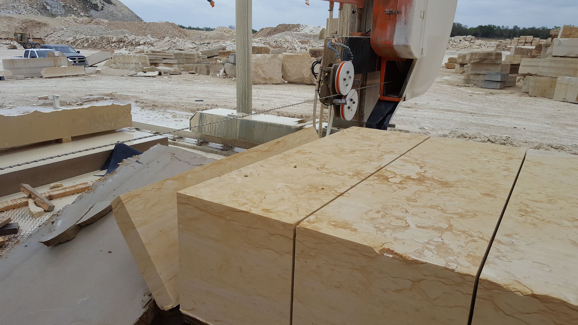 A machine is cutting blocks of stone in a quarry.