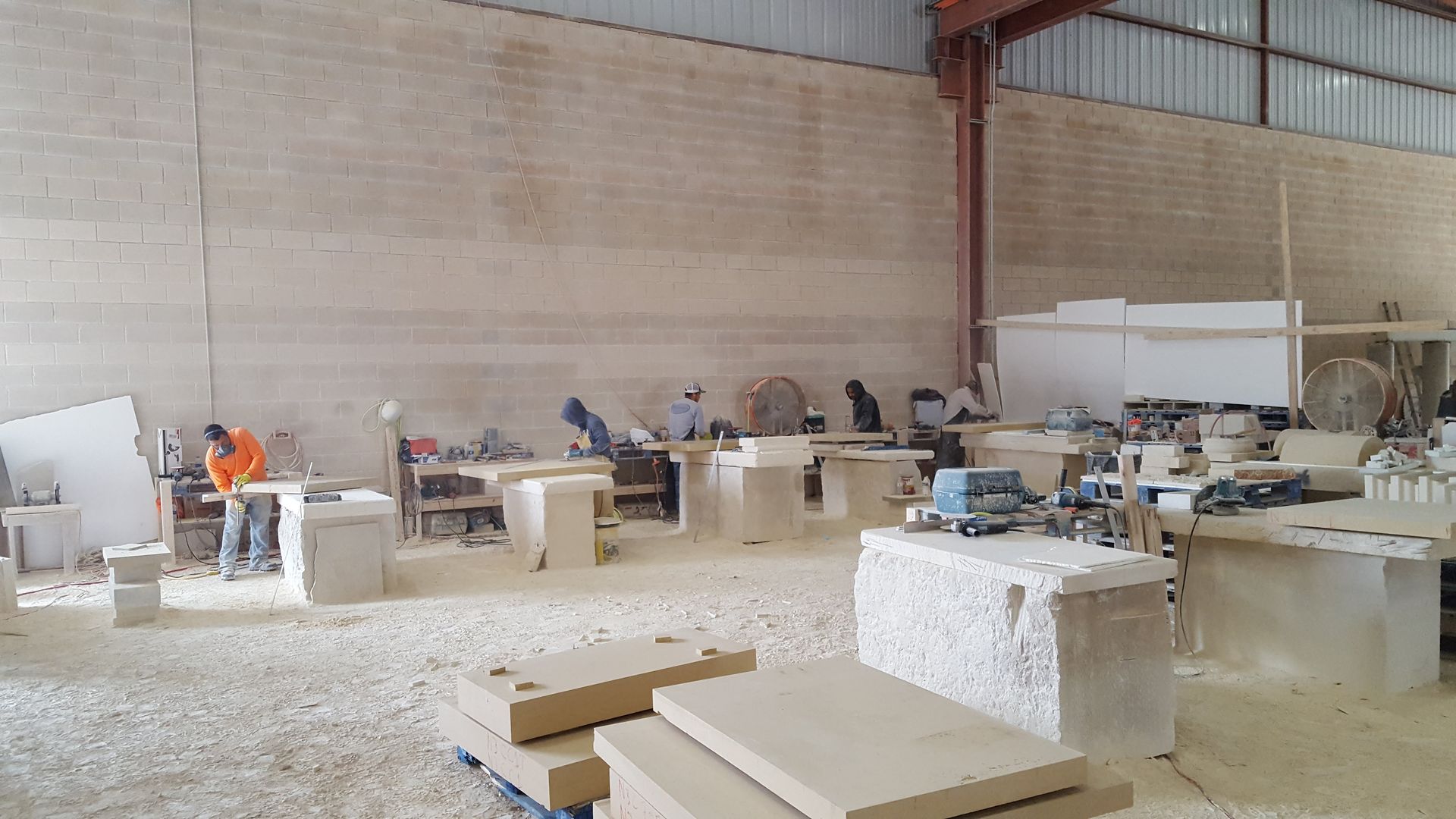 A group of people are working in a large warehouse.