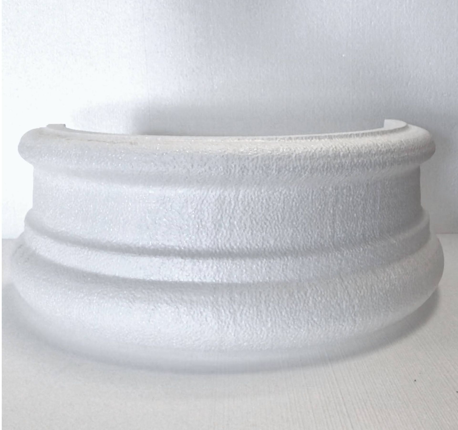 A white object is sitting on a white surface