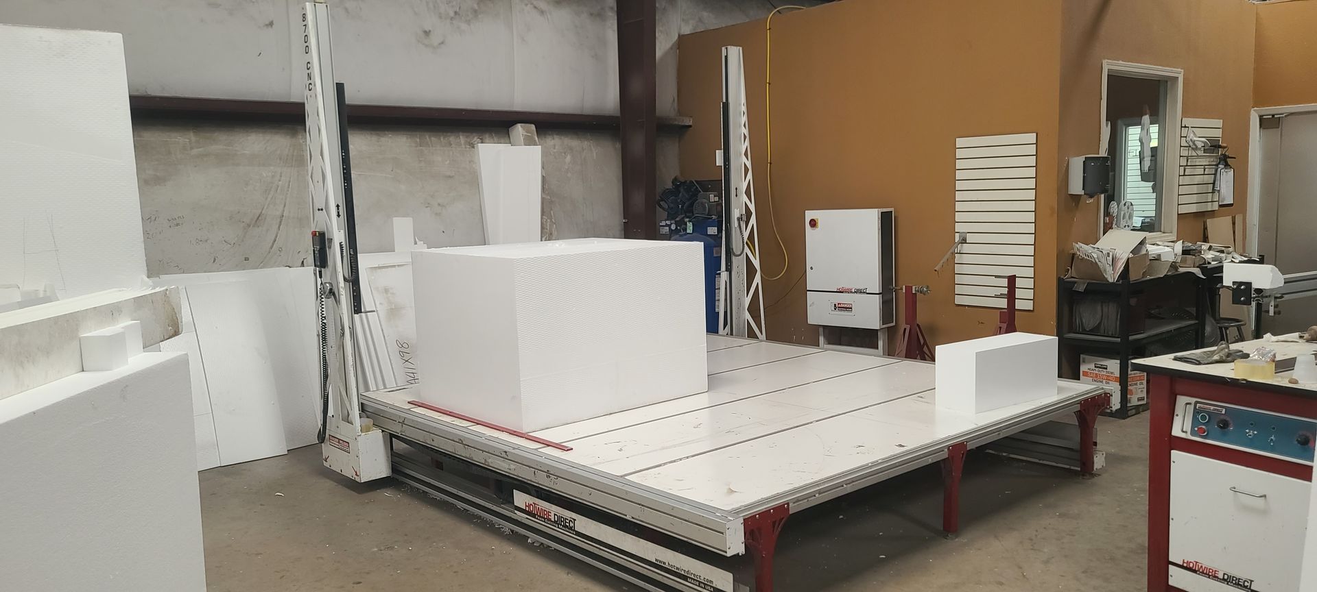 A warehouse filled with lots of white boxes and a machine.