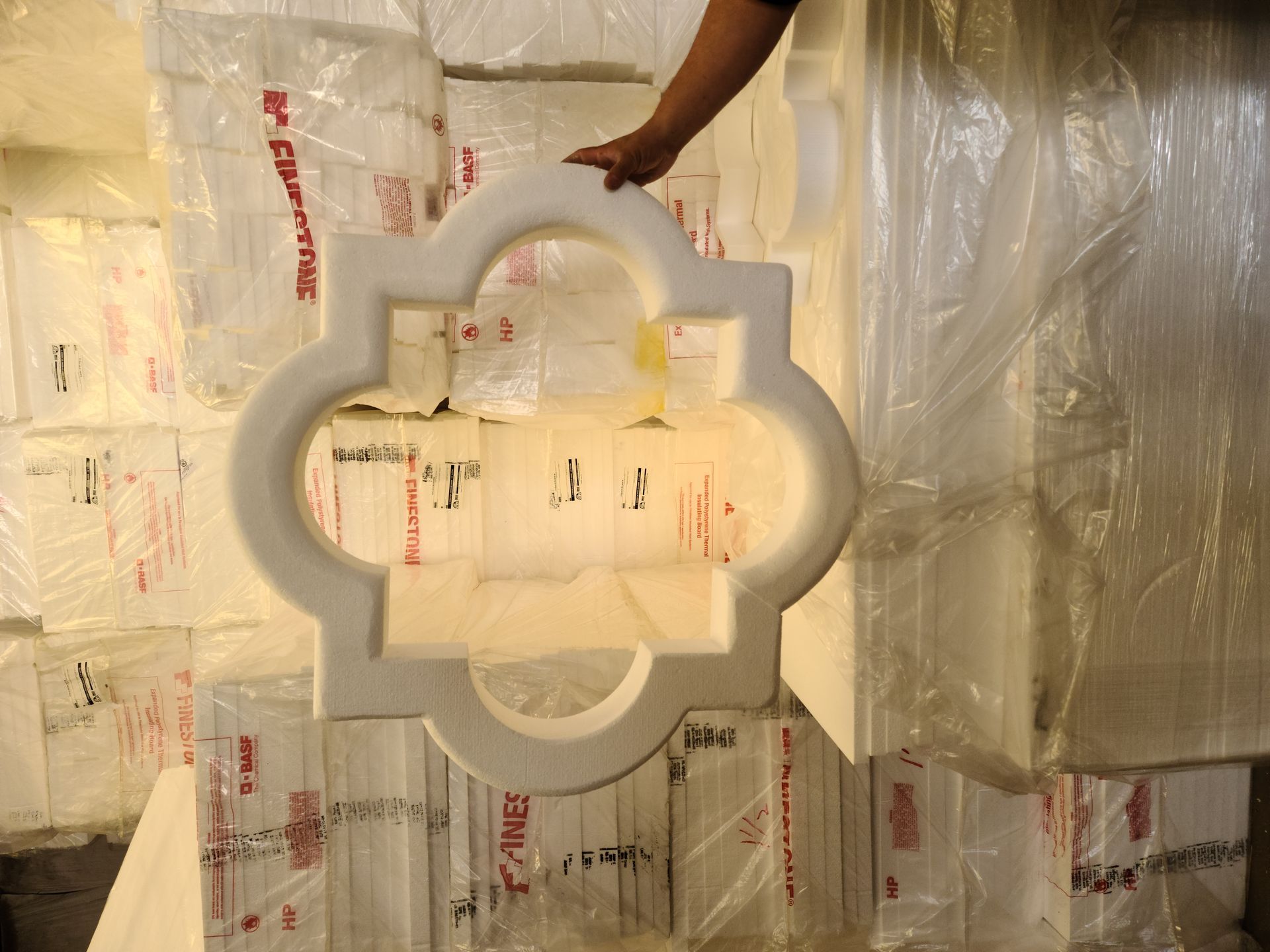 A person is holding a piece of styrofoam in their hand