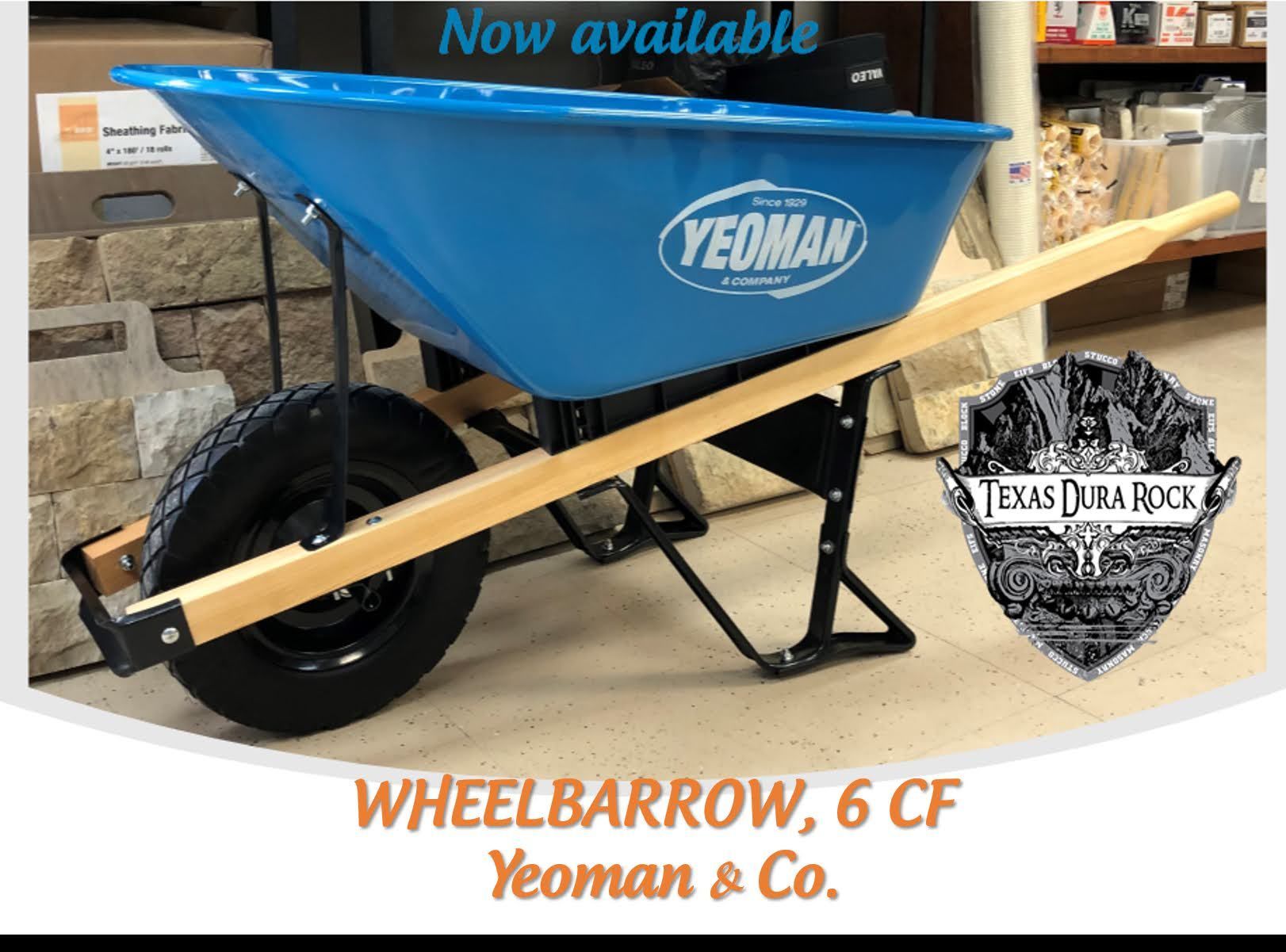 A blue wheelbarrow with a wooden handle from yeoman & co.