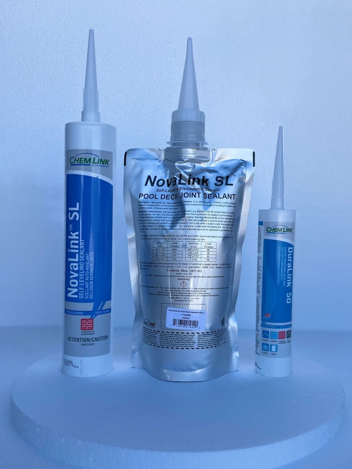 Three bottles of silicone sealant are sitting on a table.
