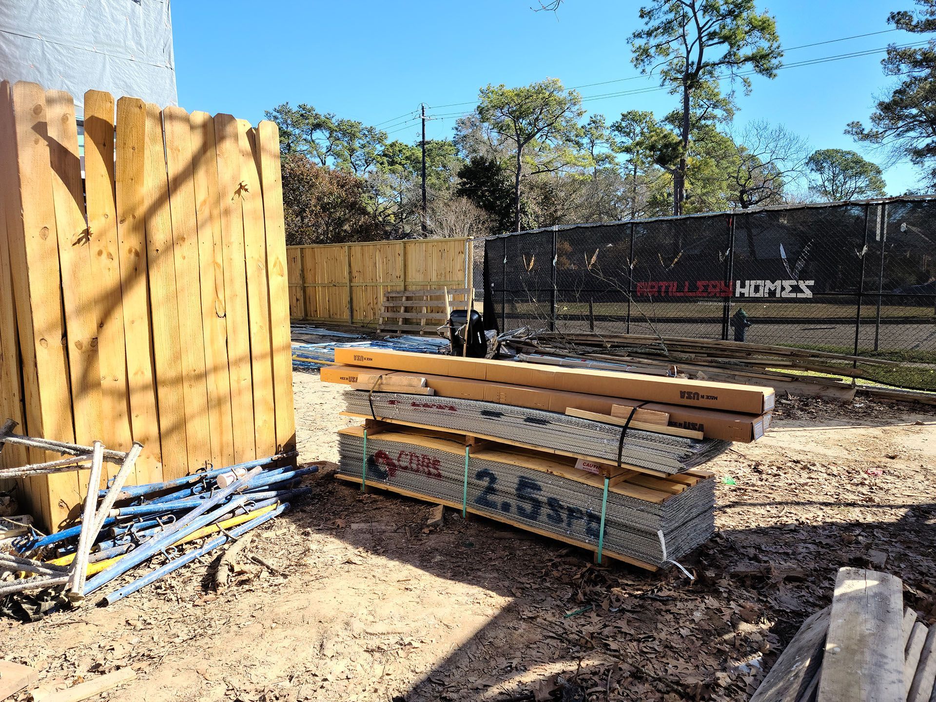A pile of wood is stacked on top of each other on a construction site.