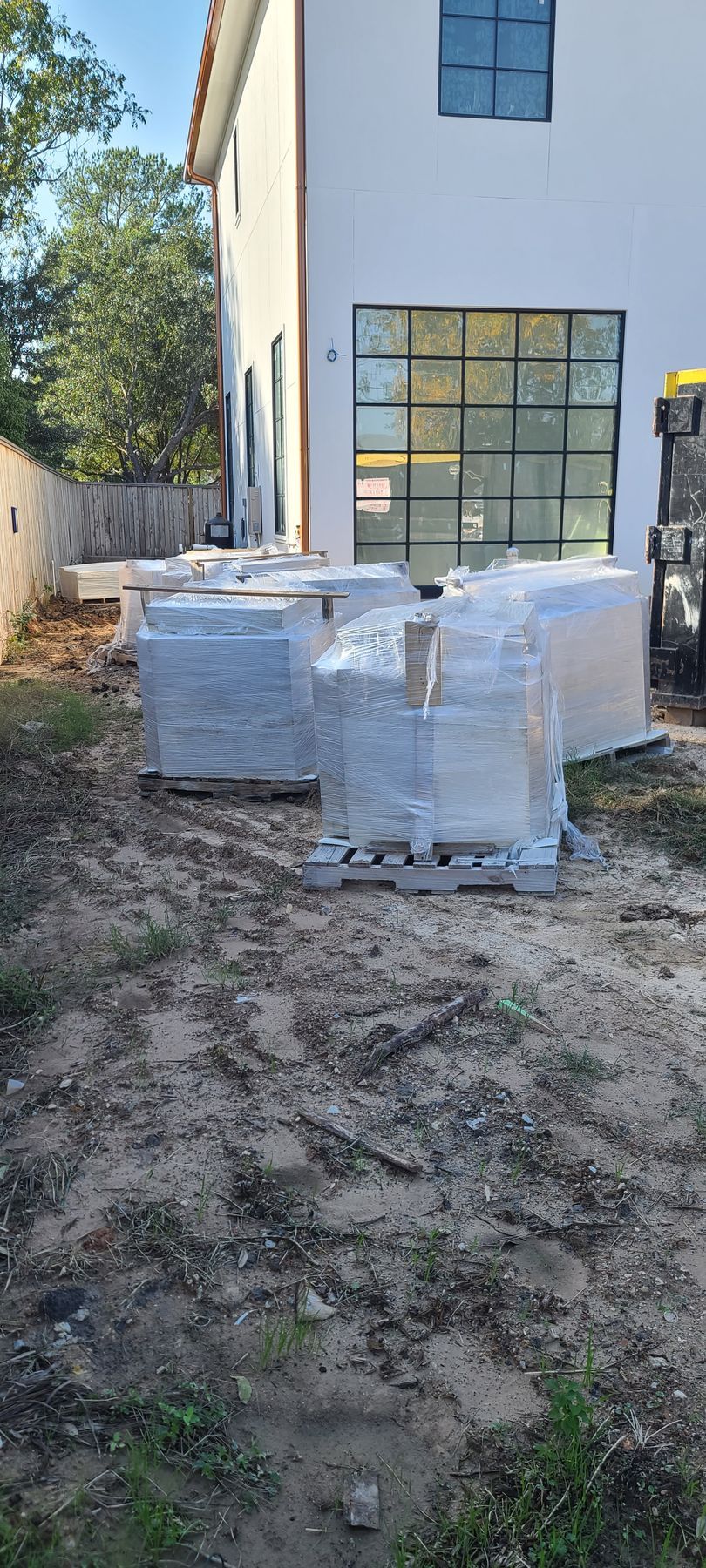 A bunch of boxes are sitting in front of a house.