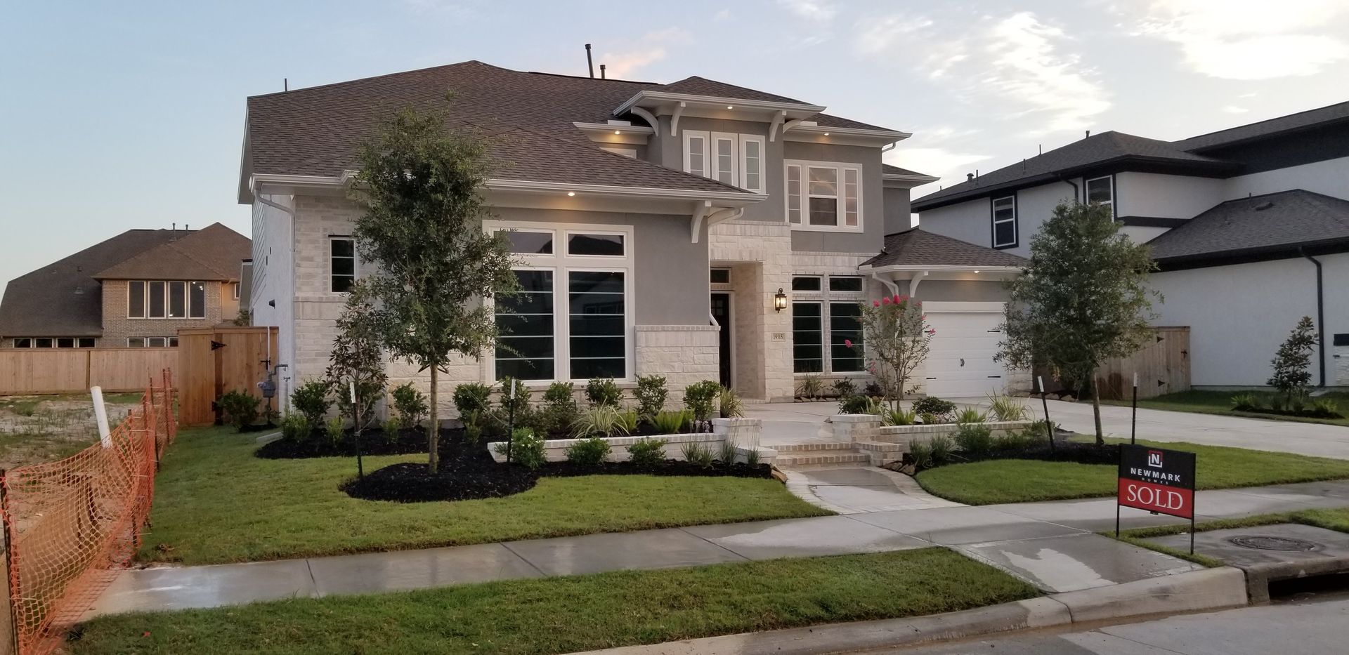 A large house with a for sale sign in front of it