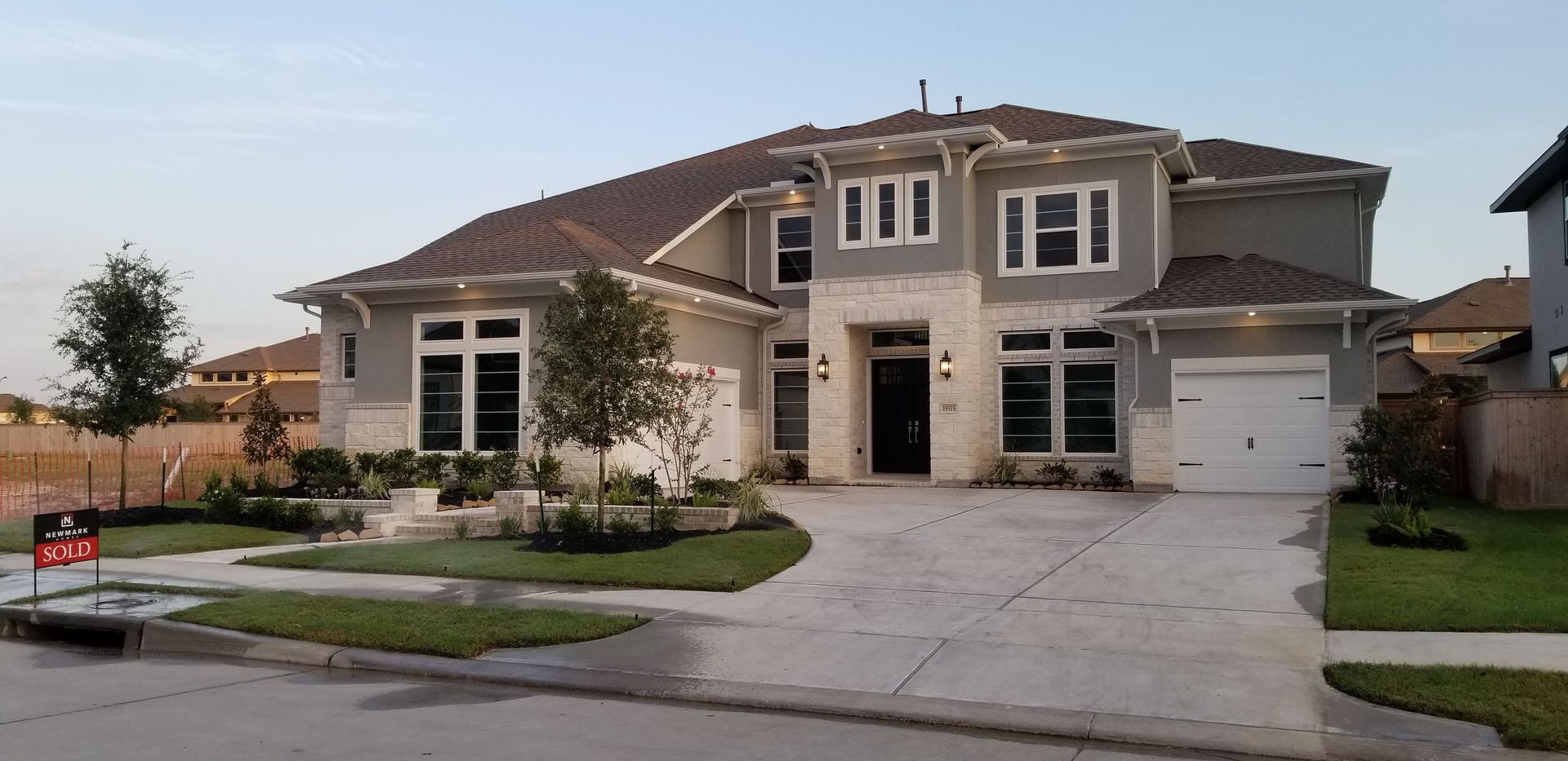 A large house with a for sale sign in front of it